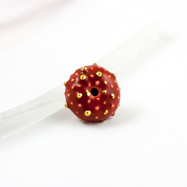 Burgundy color brooch with golden dots