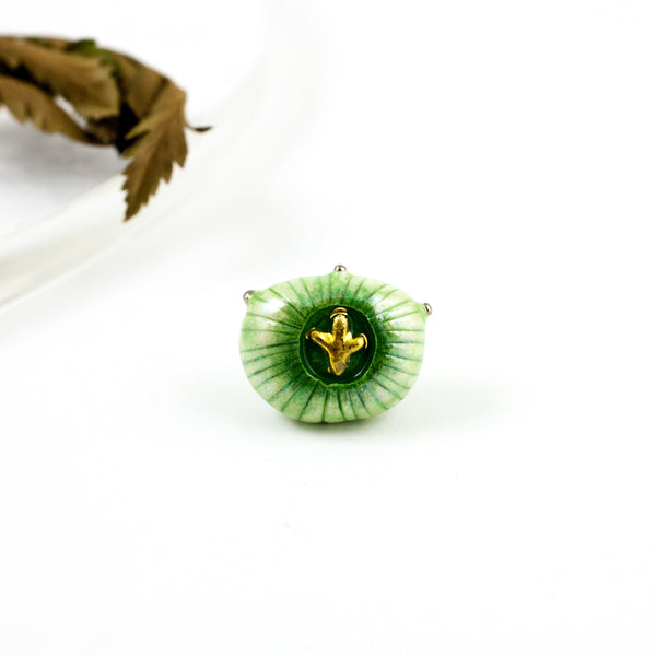 Green ceramic brooch with a gold flower and pearl lusters
