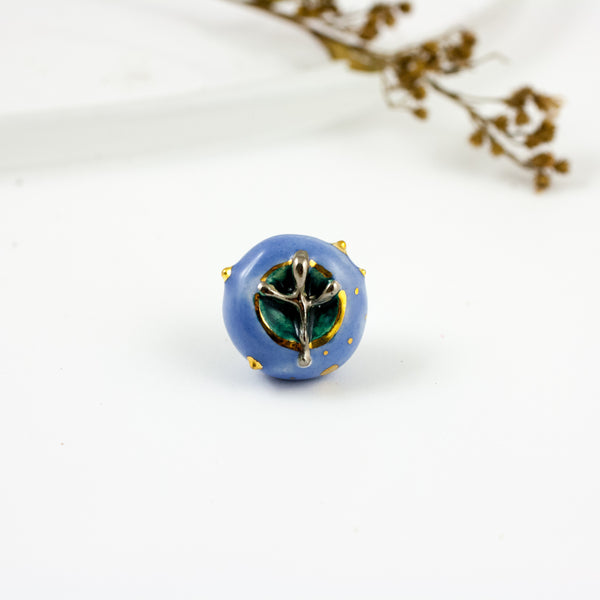 Bright blue brooch with a platinum flower