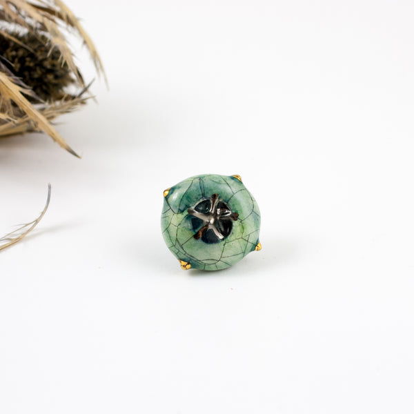 Ocean blue cracle ceramic brooch with a platinum flower
