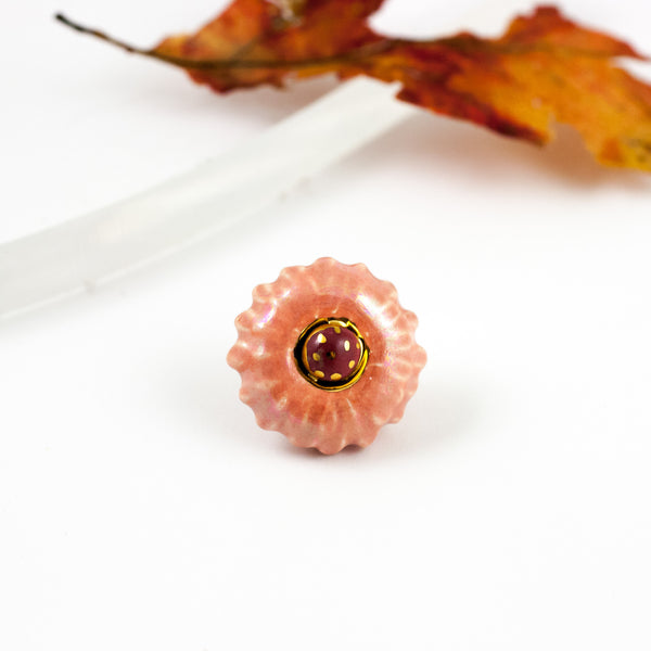 Pink and red flower-shaped brooch with pearl luster