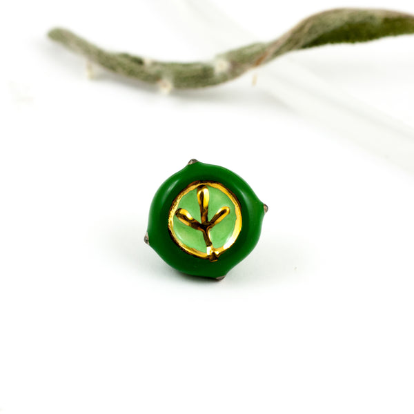 Dark green ceramic brooch with gold and platinum lusters