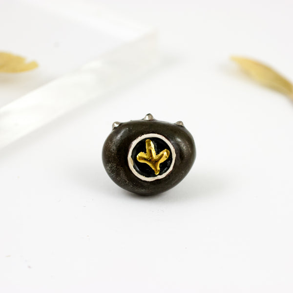 Black ceramic brooch with a golden flower