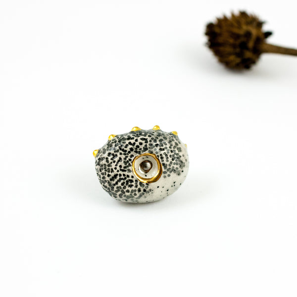 Black speckled brooch with fine metal lusters