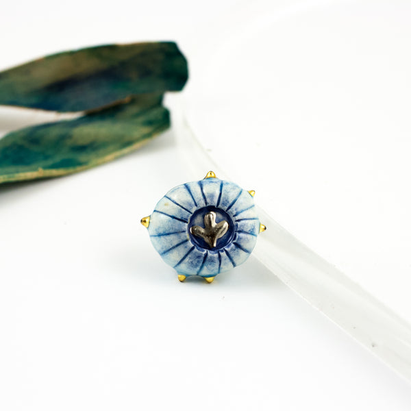 Blue color organic form brooch with pearl luster and a platinum flower