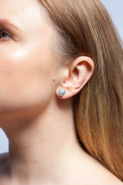 Grey asymmetrical flower and heart silver stud earrings