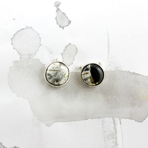 Mismatched dark earrings with platinum luster