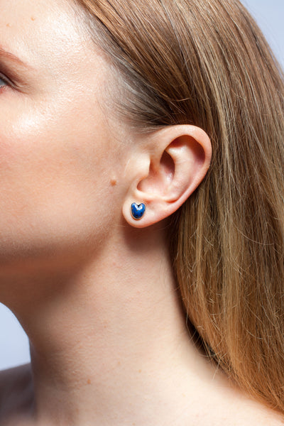 Blue mismatched silver earrings with a ceramic flower and a heart