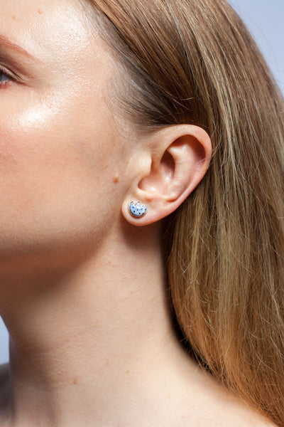 Blue mismatched silver earrings with a ceramic flower and a heart