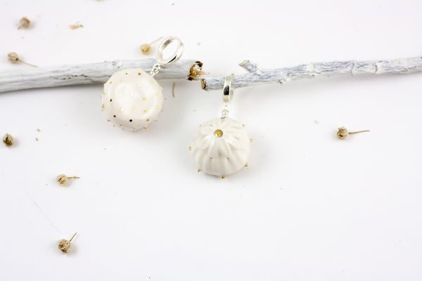 White organic form dangle earrings with dots