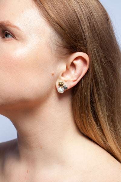 Mismatched silver stud earrings with freshwater pearls and ceramic hearts