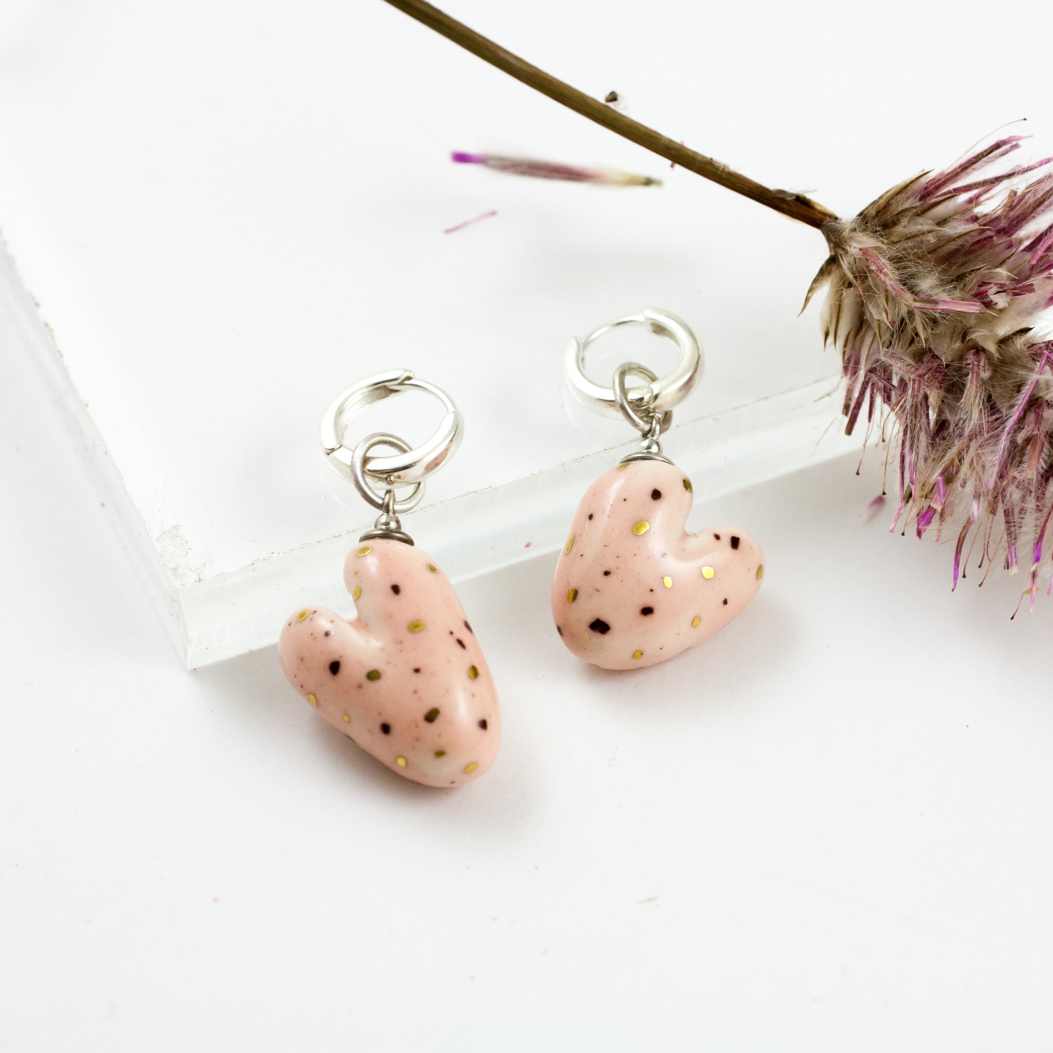 Pink heart form earrings with gold dots