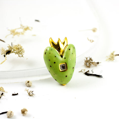 Bright green heart-shaped brooch with gold crown and spots