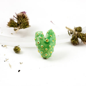 Bright green heart-shaped brooch with gold spots