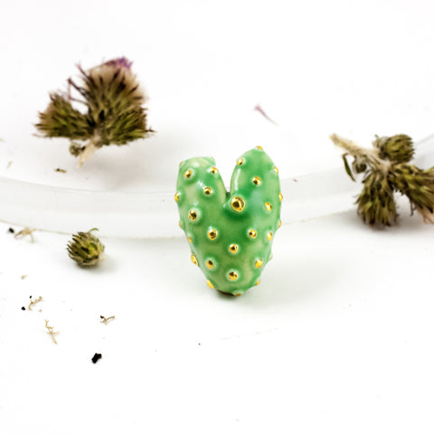 Bright green heart-shaped brooch with gold spots