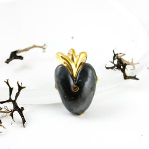 Black heart-shaped brooch with gold crown and dots
