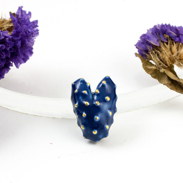 Blue heart-shaped brooch with a gold luster dots