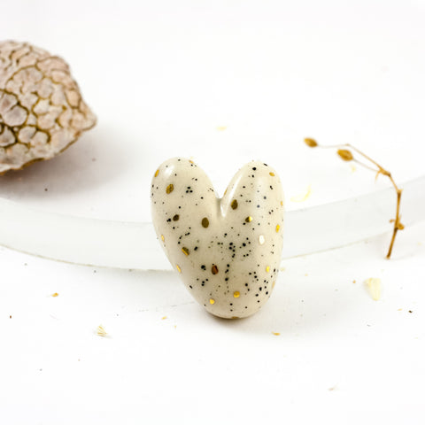 Ivory heart-shaped brooch with gold dots