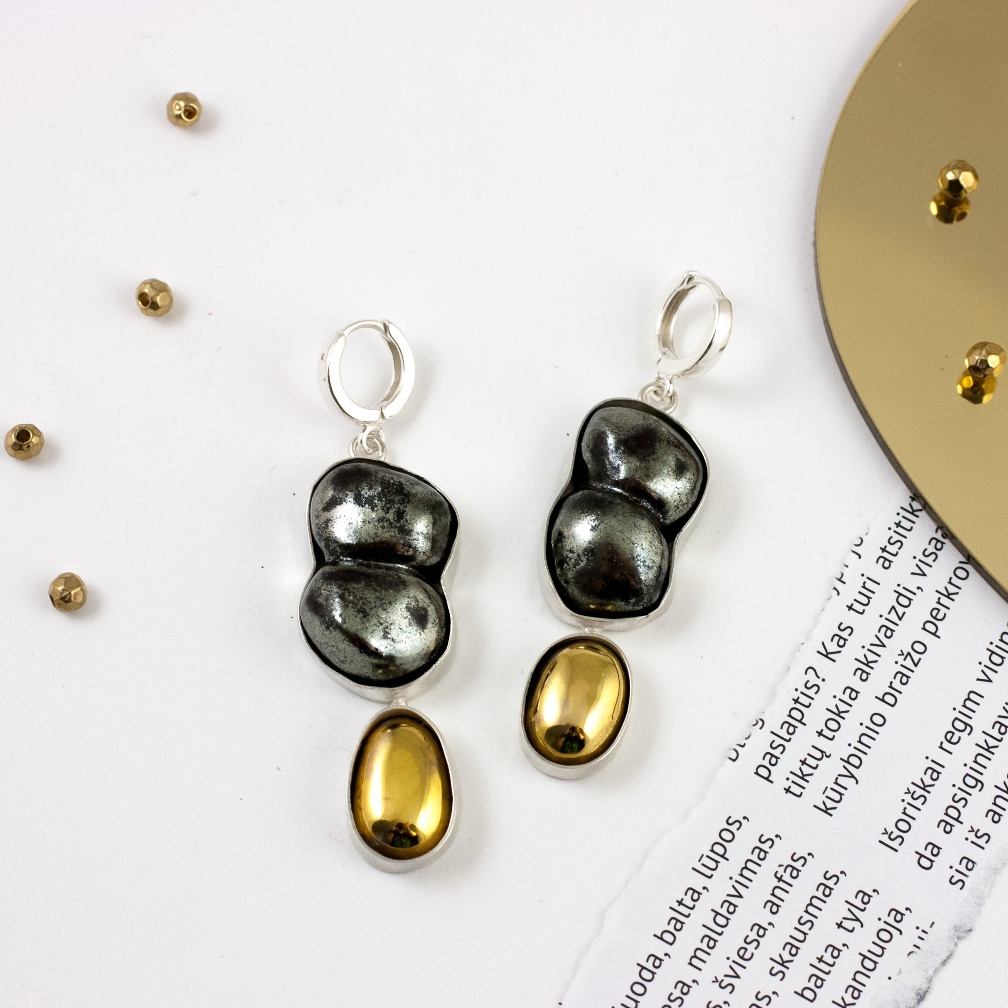 Dangle black mismatched earrings with gold luster