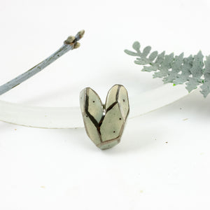 Grey heart-shaped brooch with dots and lines