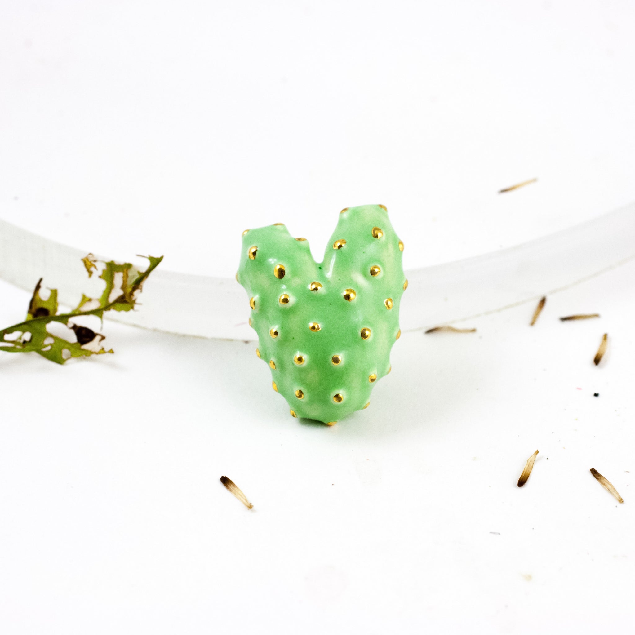 Bright green heart-shaped ceramic brooch with gold luster