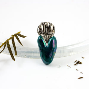 Dark green heart-shaped ceramic brooch with platinum luster crown