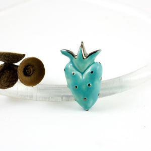 Turquoise color heart-shaped brooch with a platinum luster