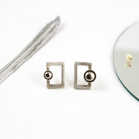 Mismatched silver stud earrings with platinum plated ceramics