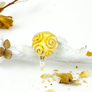 Yellow ceramic brooch with gold onaments and white pearl