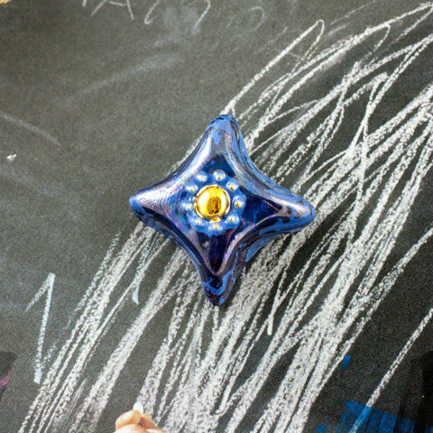 blue brooch with gold center