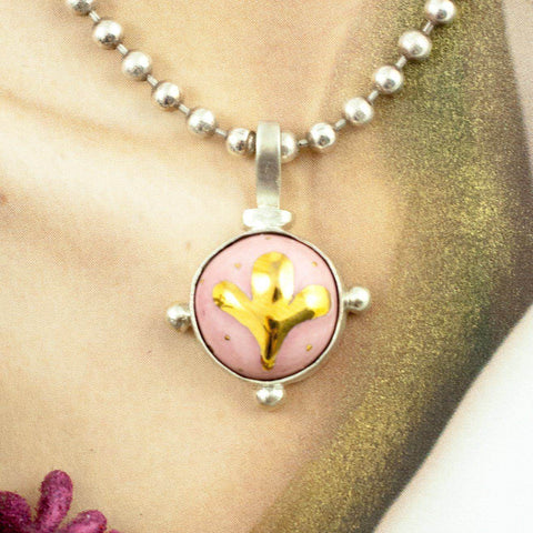 round pink pendant with golden flower